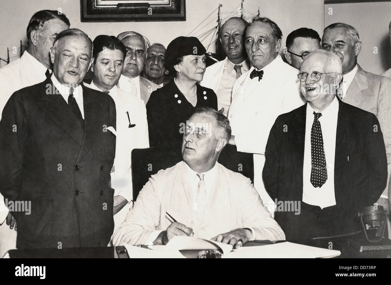 President Franklin Roosevelt signing the Social Security Act. Among those with the President are Sen. Alben Barkley, Sen. Stock Photo