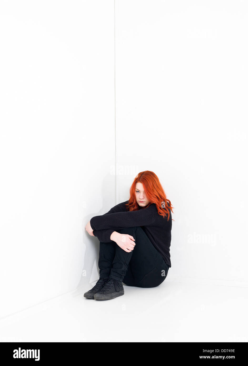 Young woman sad corner hi-res stock photography and images - Alamy
