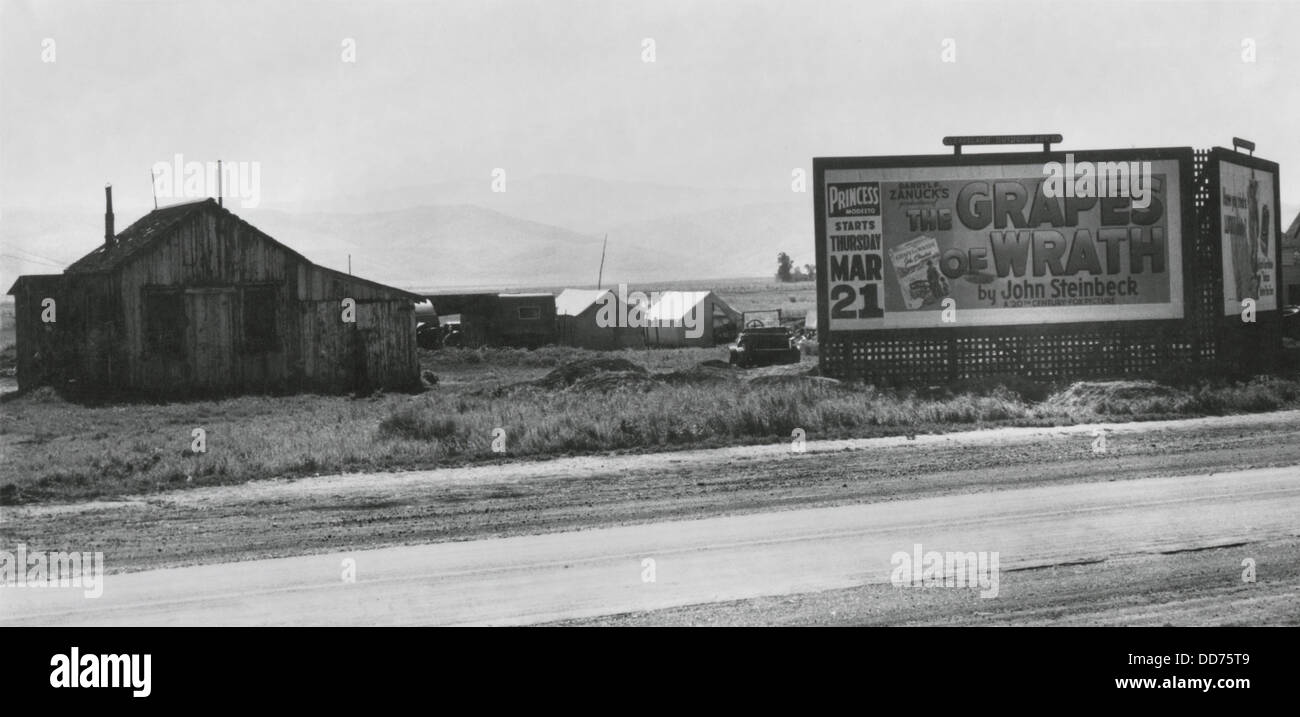 Roadside migrant camp behind, 'Grapes of Wrath,' billboard, April 1940