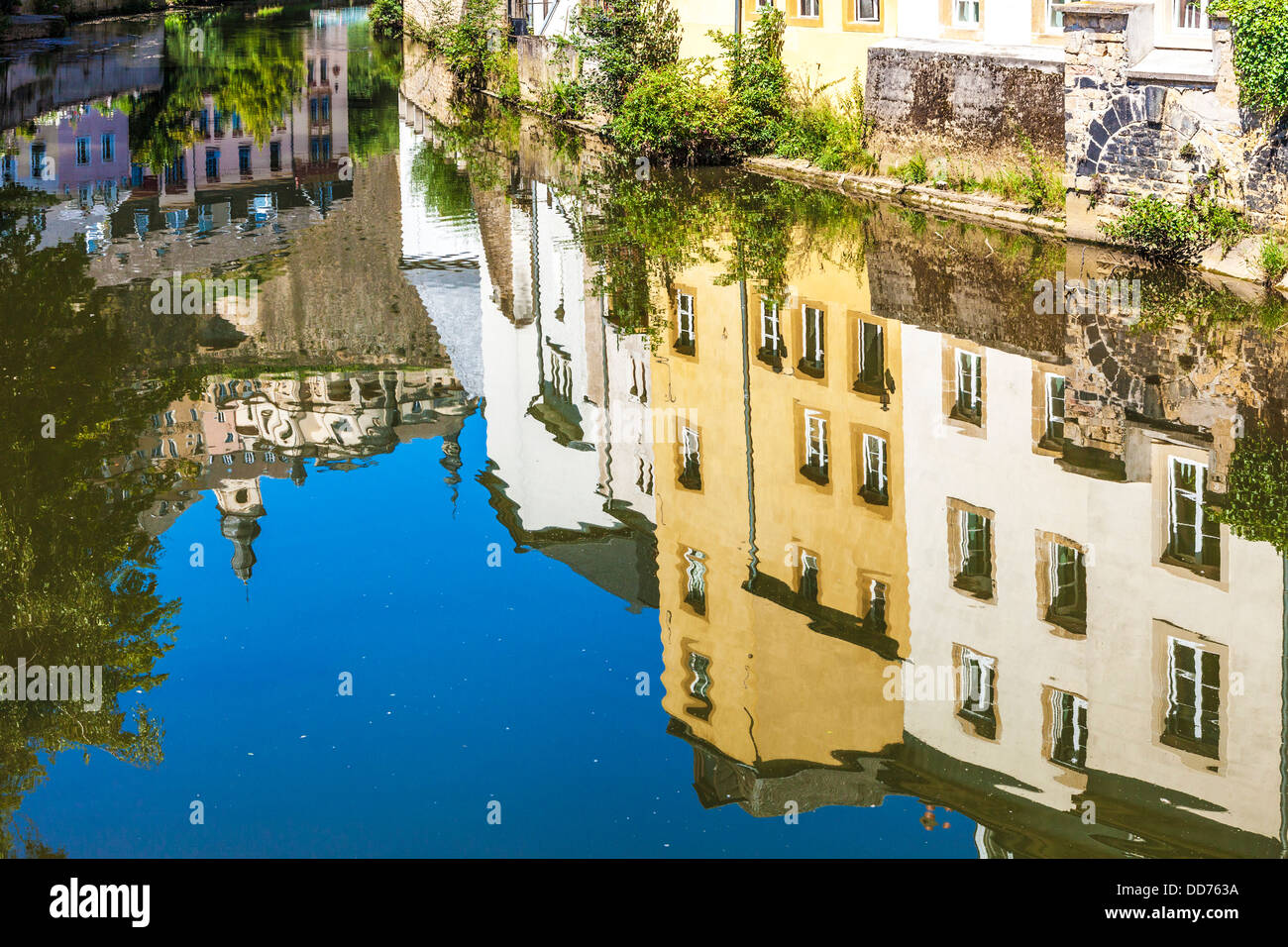 Reflections of the medieval Ville Haute and houses in the waters of the River Alzette in the Grund district of Luxembourg City. Stock Photo