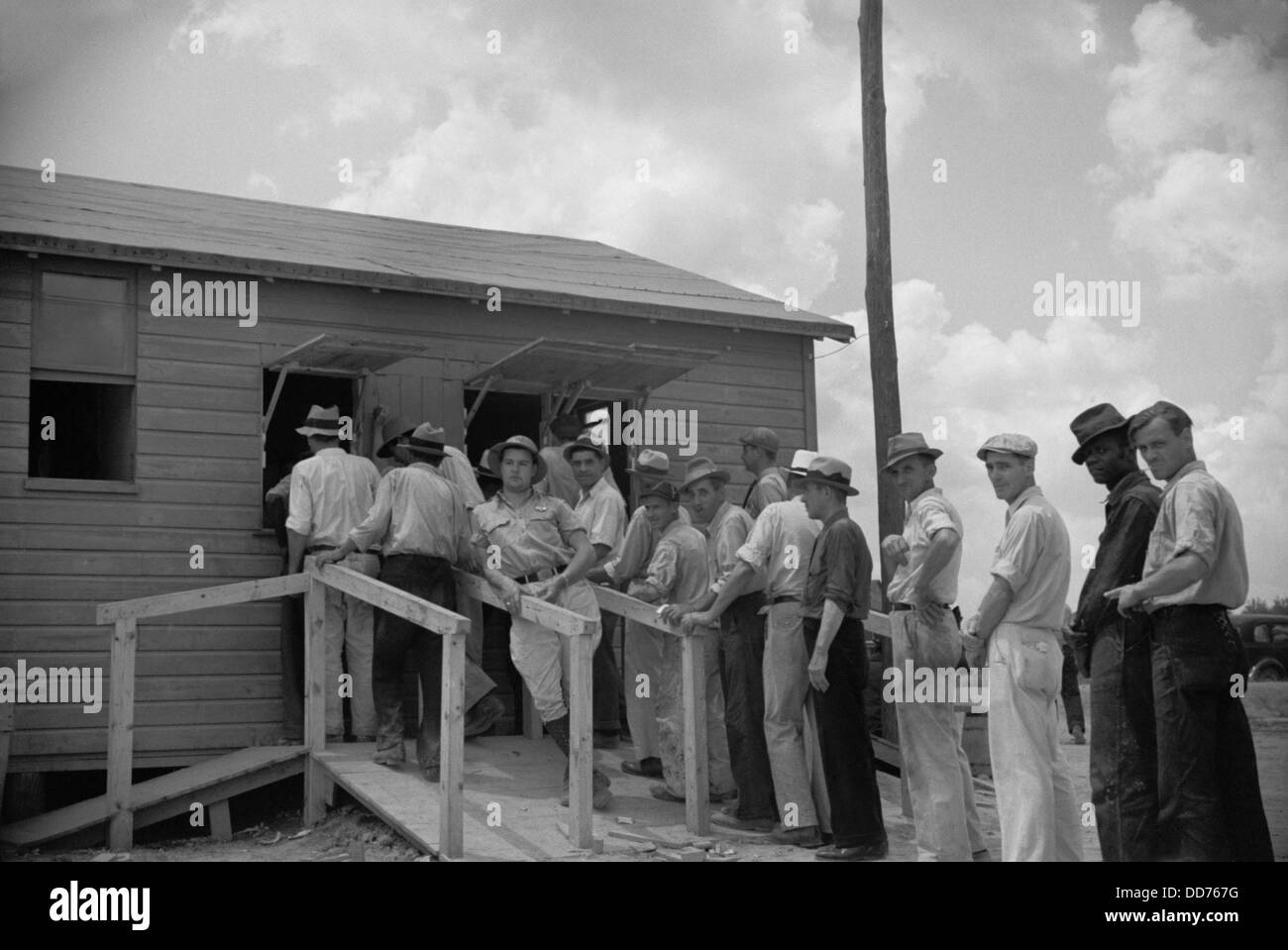 Workmen receiving paychecks at New Deal worksite, July 1936. They were building the Greenbelt, Maryland, planned community. Stock Photo