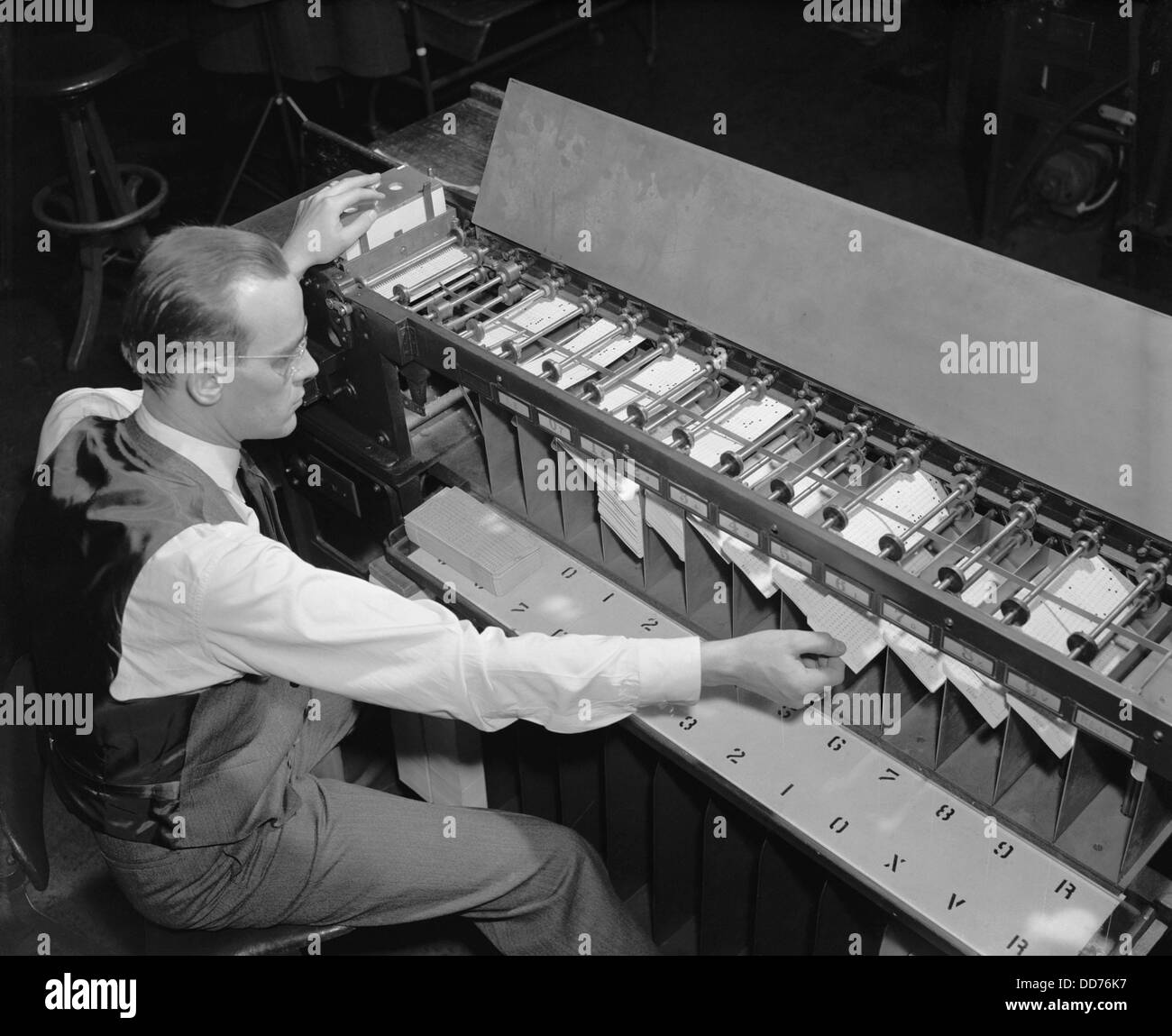 U.S. Bureau of the Census computer operator at a punch card sorter, ca. 1940. (BSLOC 2013 8 187) Stock Photo