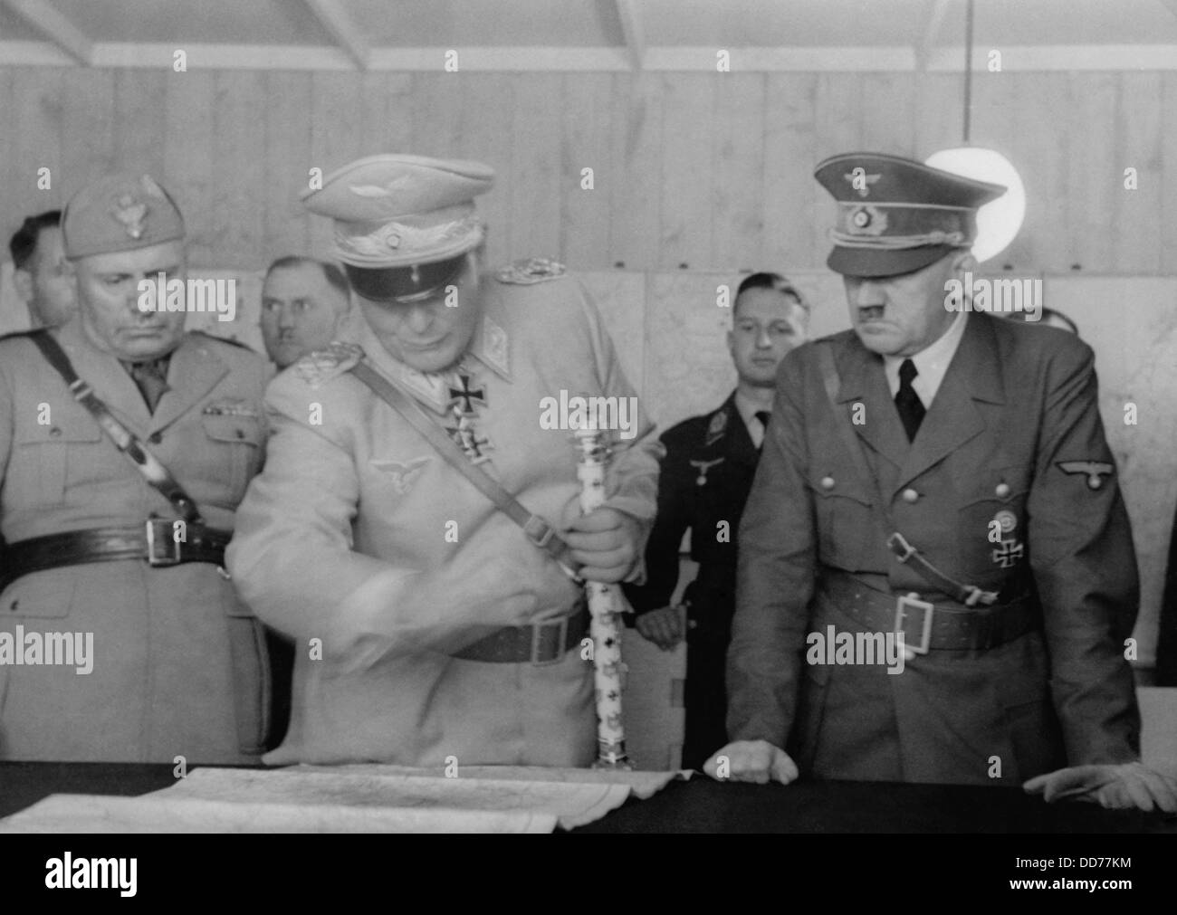 Adolf Hitler, Hermann Goering, and Benito Mussolini looking at map, August 26, 1941. German military officers standing behind Stock Photo