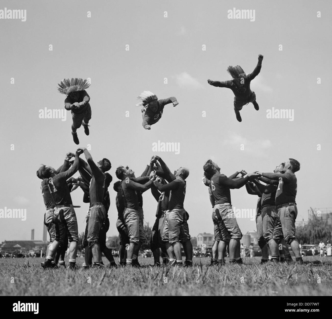 Washington Redskins training by 'flying thru the air', Aug, 28, 1937. Aloft  in Native American style war bonnets, L-R: Wayne Stock Photo - Alamy