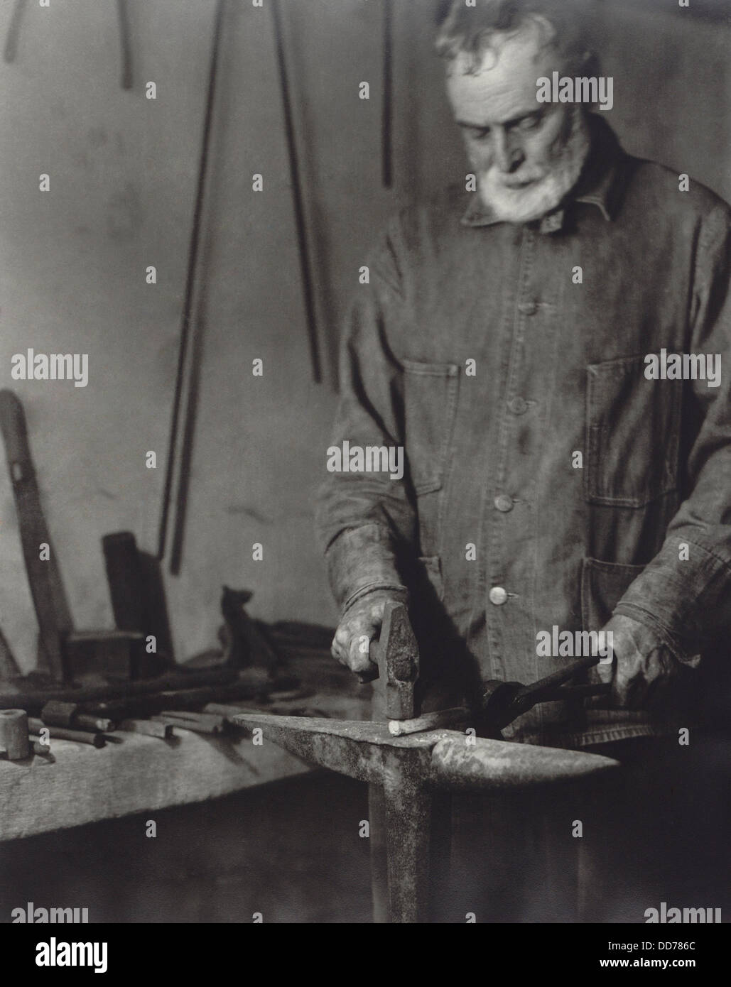 Brother Ricardo Belden blacksmithing, at the Hancock Shaker Village near Pittsfield, Massachusetts. 1935 photo by Samuel Stock Photo