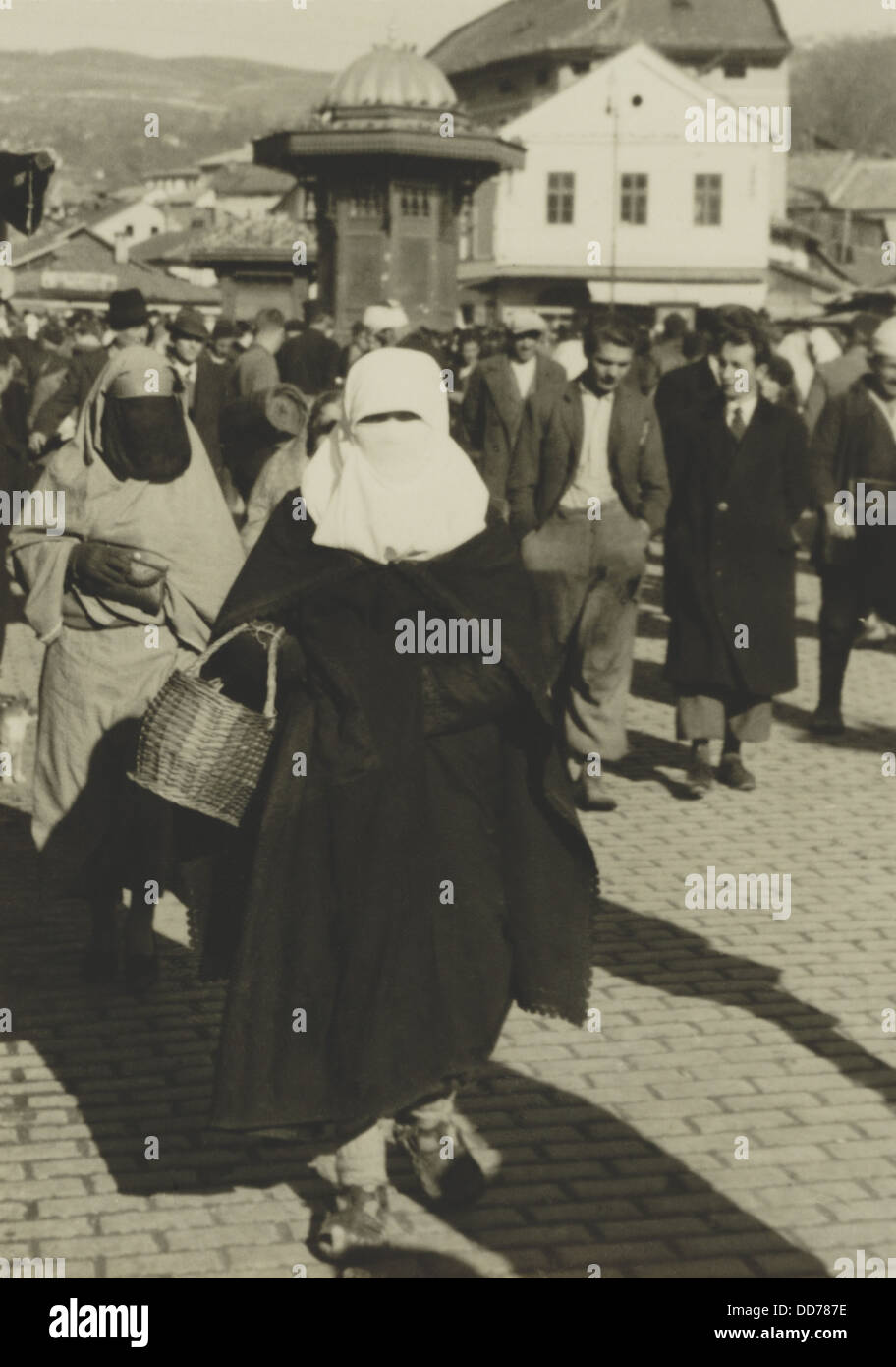 Yugoslavian Islamic woman in niqab and burqa carrying basket in Sarajevo, 1936. (BSLOC 2013 9 99) Stock Photo