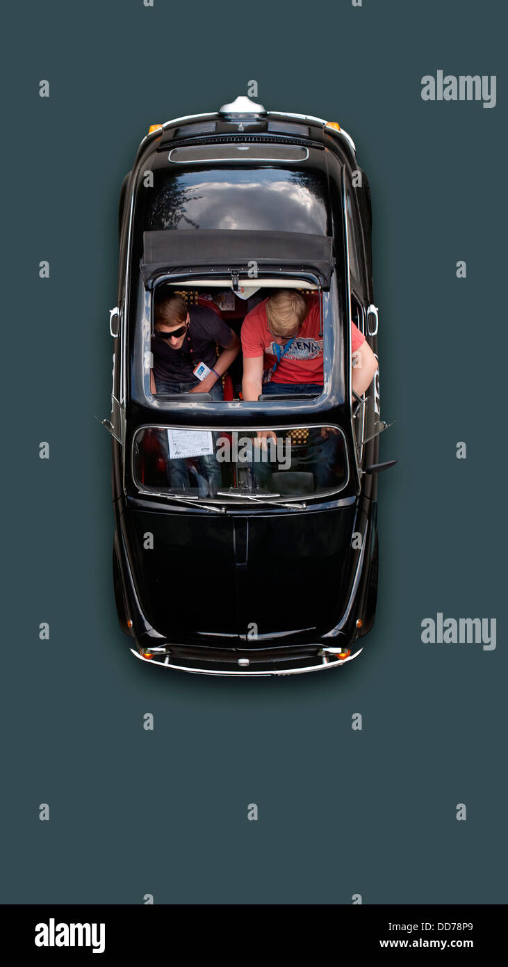 Germany, Hesse, Young men sitting in Fiat 500L Nuova Stock Photo