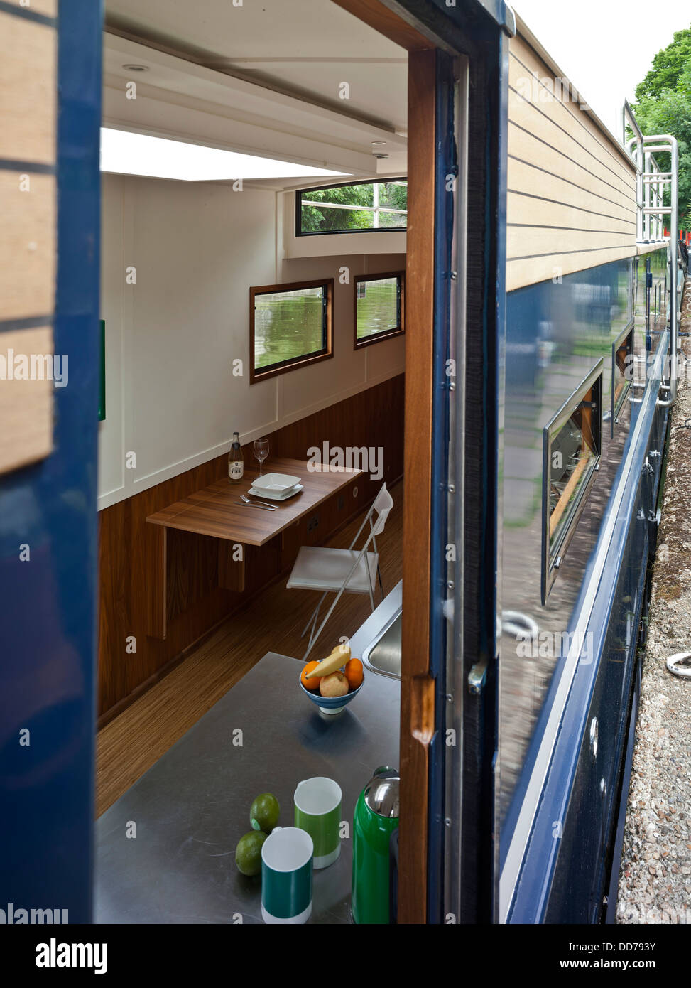Narrowboat, London, United Kingdom. Architect: Pete Young, 2013. Inside outside view through door showing fold down table. Stock Photo