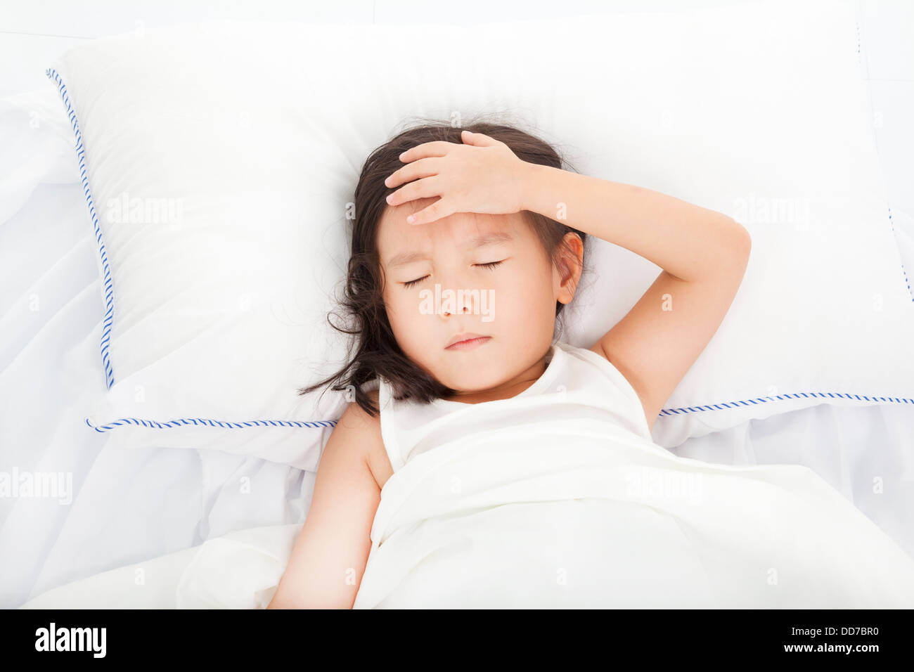 Little girl with illness on the bed Stock Photo