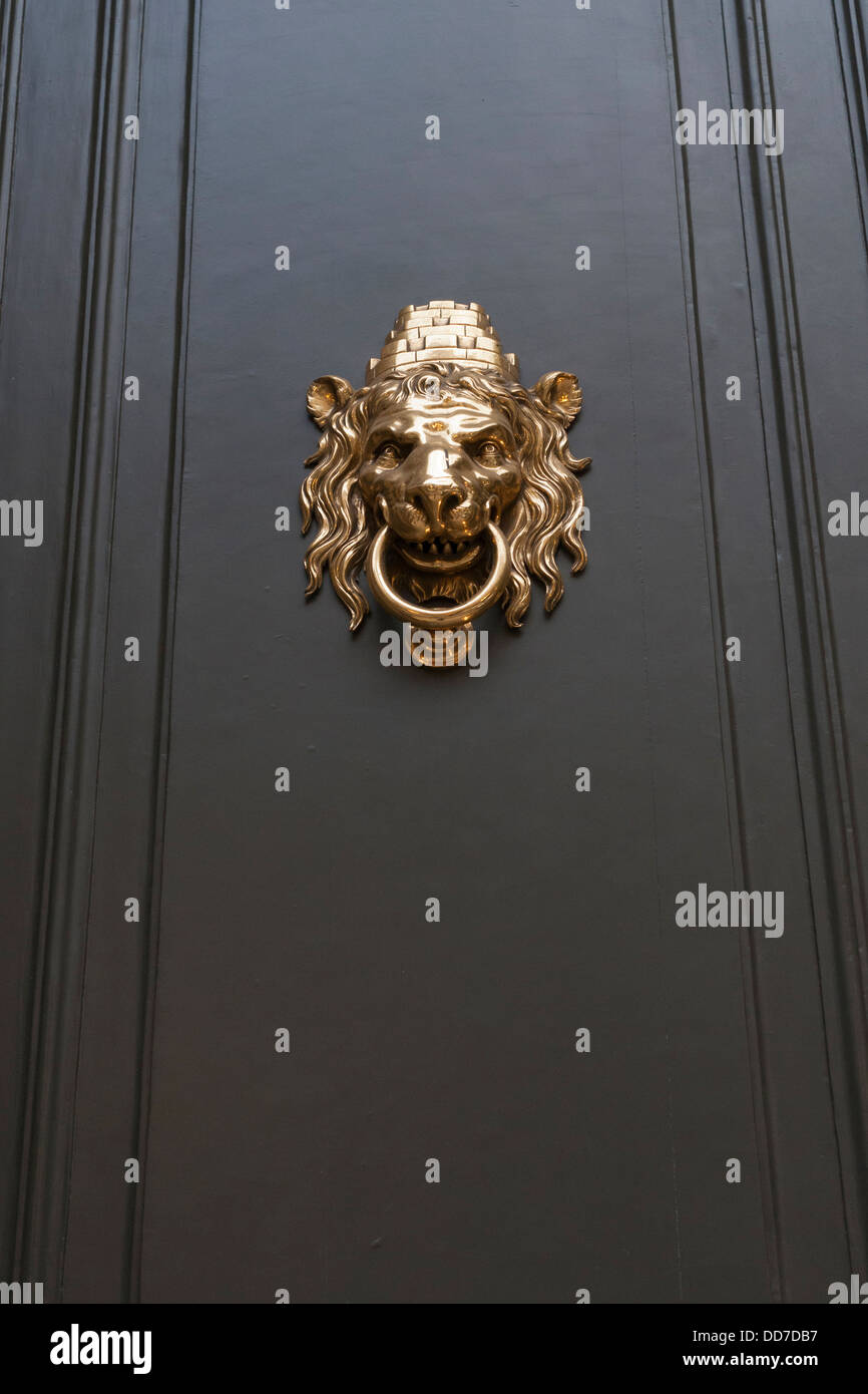metallic door handle in shape of lion head with big knocking ring Stock Photo