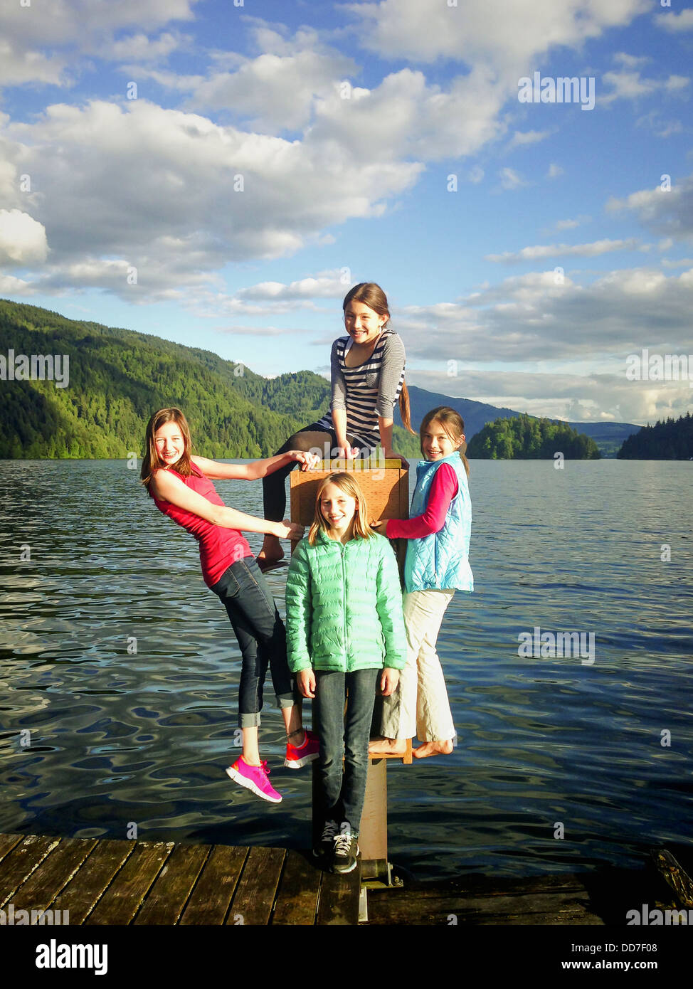 Girls playing together on wooden dock - Smartphone Captured Stock Image