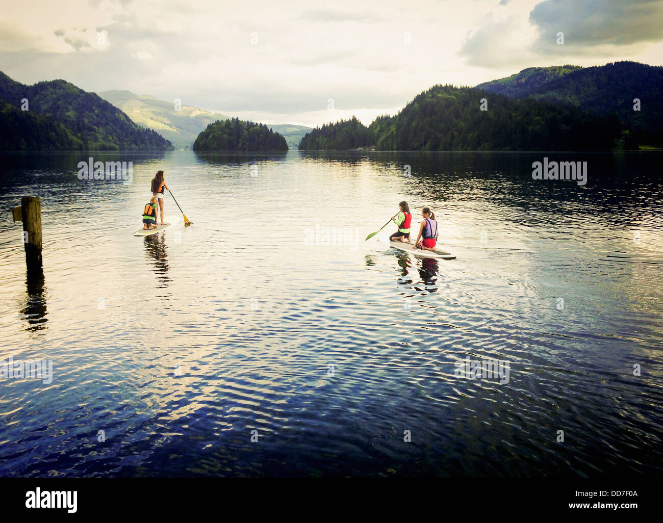 Girls paddle boarding on lake - Smartphone Captured Stock Image