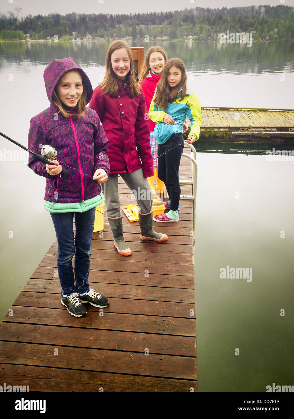 Girls fishing off wooden dock - Smartphone Captured Stock Image