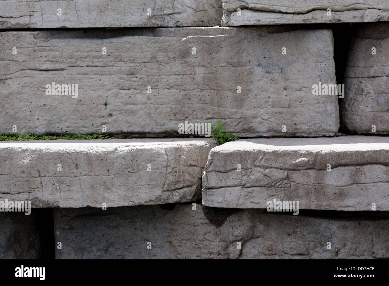 This is a wall of stone blocks in a public park. Stock Photo