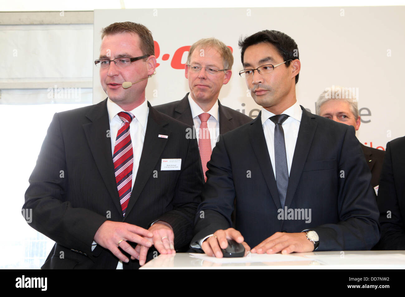 Falkenhagen, Germany. 28th Aug, 2013. German economy minister Philipp Roesler head of Eon Germany, Ingo Luge (C), and company manager Renee Schoof officialy employ the hydrogen facility 'Power-to-Gas' of the Eon Gas Storage turning excess wind energy into hydrogen for storage in Falkenhagen, Germany, 28 August 2013. The facility is supposed to create 360 cubic meters hydrgen per hour which can be used as an energy source on days lacking wind. Photo: NESTOR BACHMANN/dpa/Alamy Live News Stock Photo