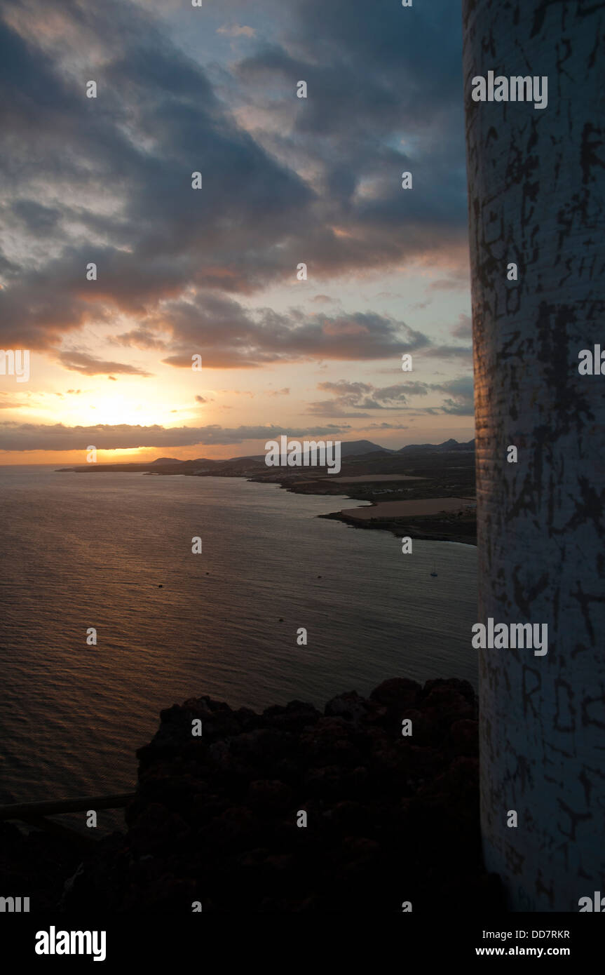 A landscape of a sea surrounded by hills covered in greenery under a ...
