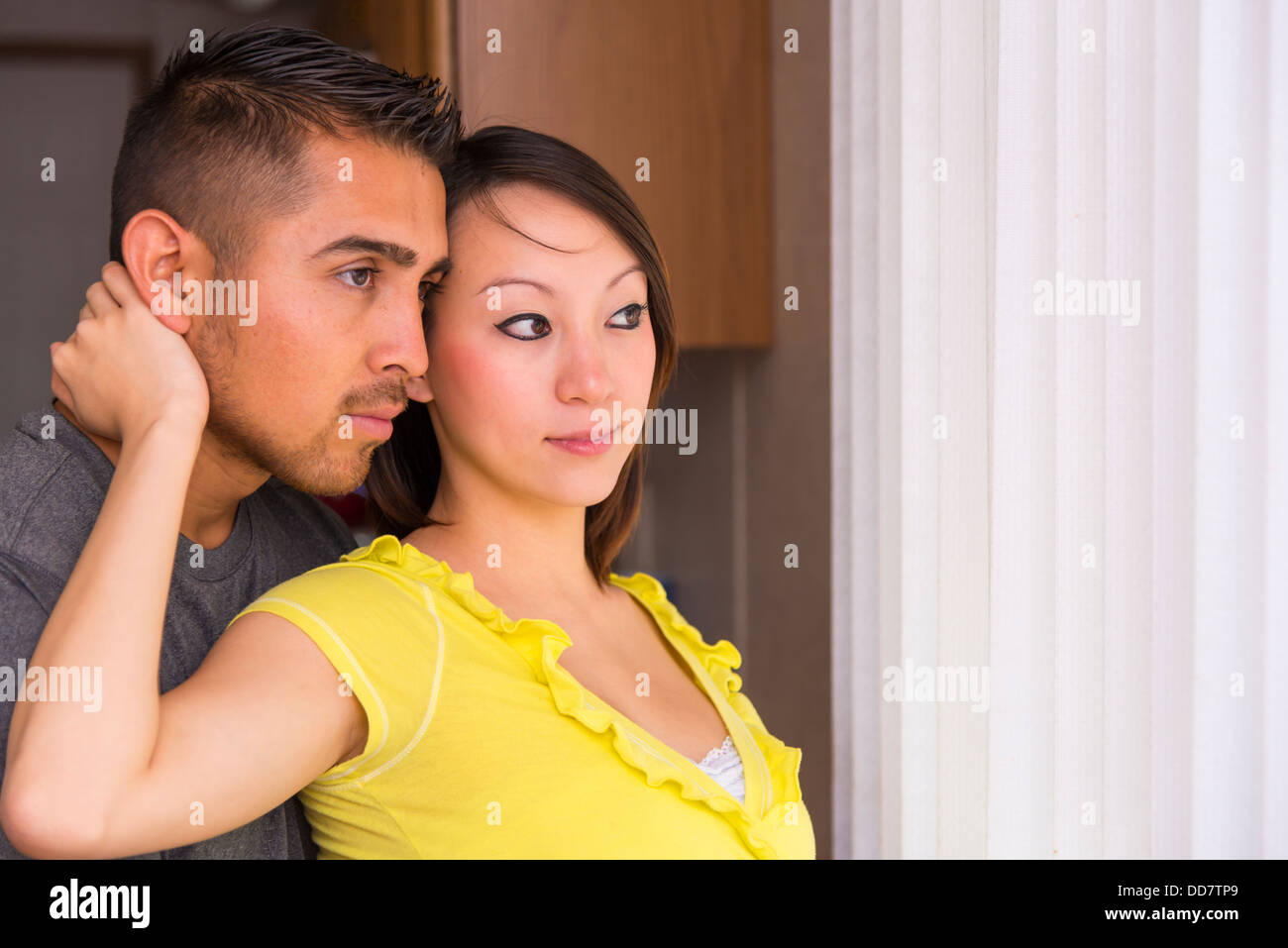 Multi ethnicity couple, Asian (Korean) woman of 20 years with Hispanic man of 25 years Stock Photo