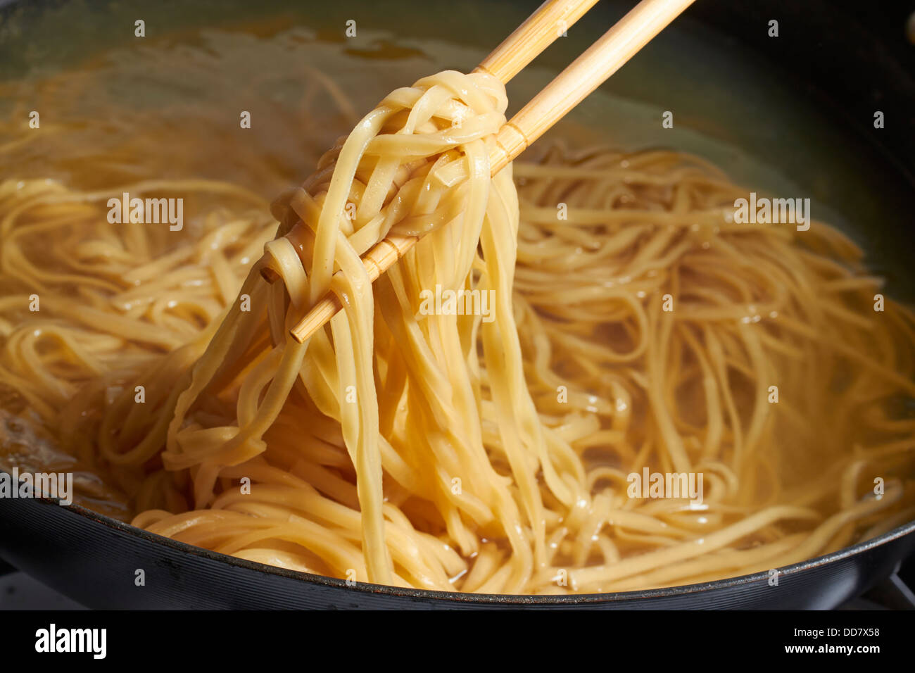 cooking Chinese egg noodles in a wok Stock Photo Alamy