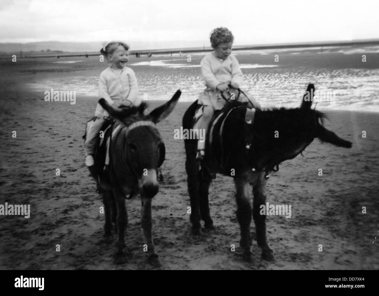 Two girls enjoying a donkey ride on the beach at Blackpool, Lancashire in the 1960's Stock Photo