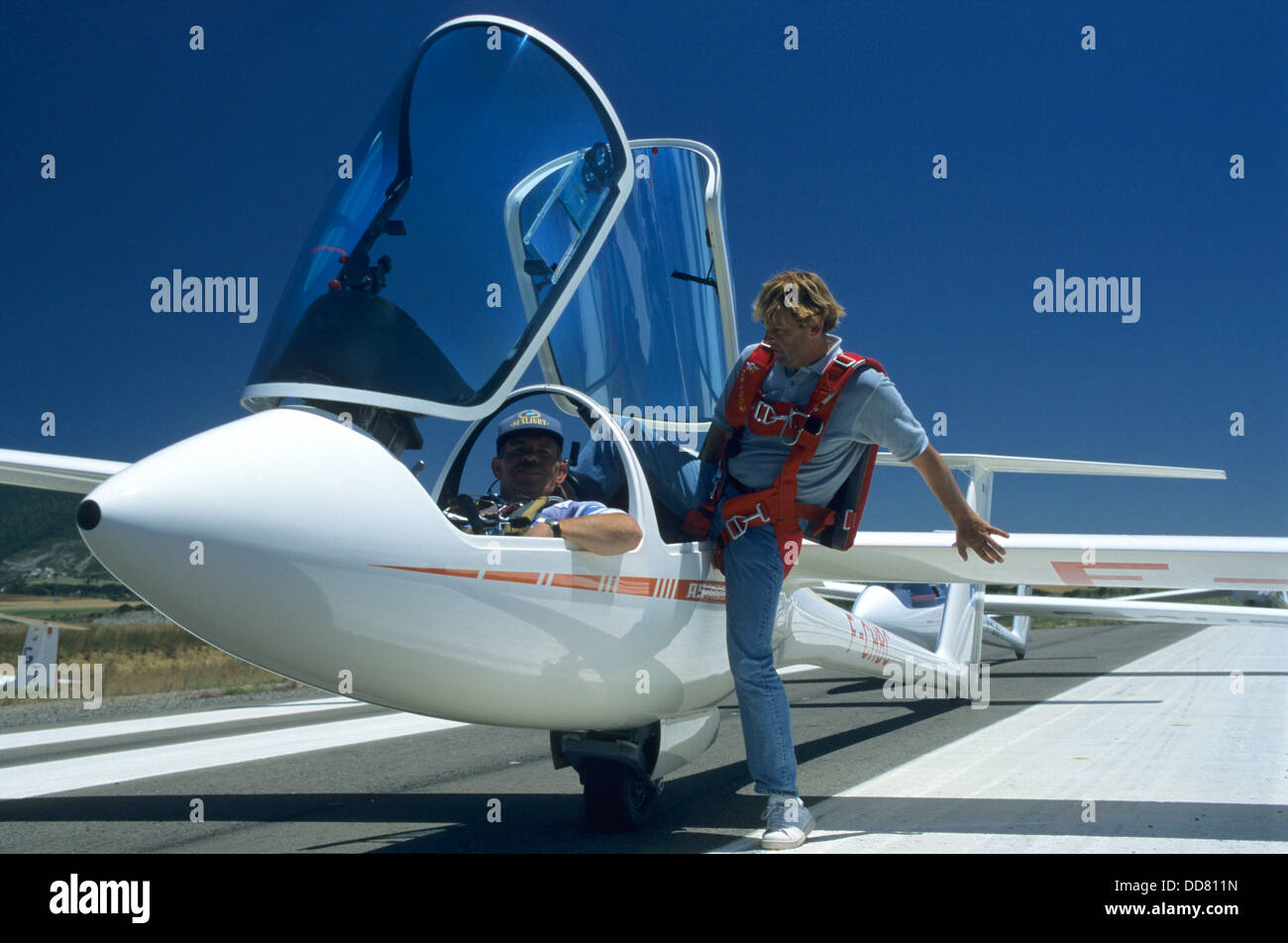 Pilots boarding in glider plane ASH-25 on runway of Santa Cilia de Jaca aerodrome, Aragon, Spain Stock Photo