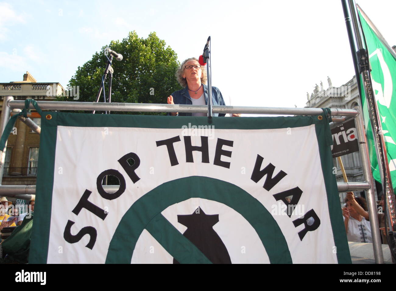 Downing Street, London. 28 Aug, 2013. Supporters of the Stop the War coalition held a demonstration against any military intervention in Syria from 5pm today. Picture shows Jane Sterk making her speech. Stock Photo