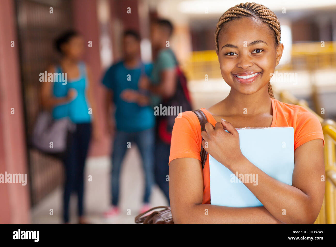 portrait of pretty female African college student looking at the camera ...