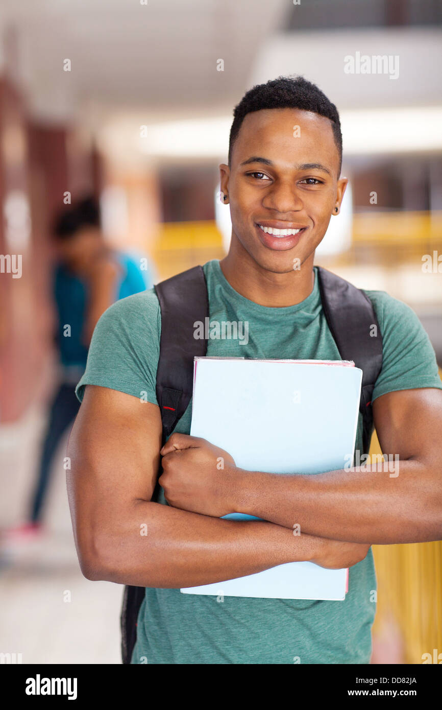 cheerful African American college student holding books Stock Photo - Alamy