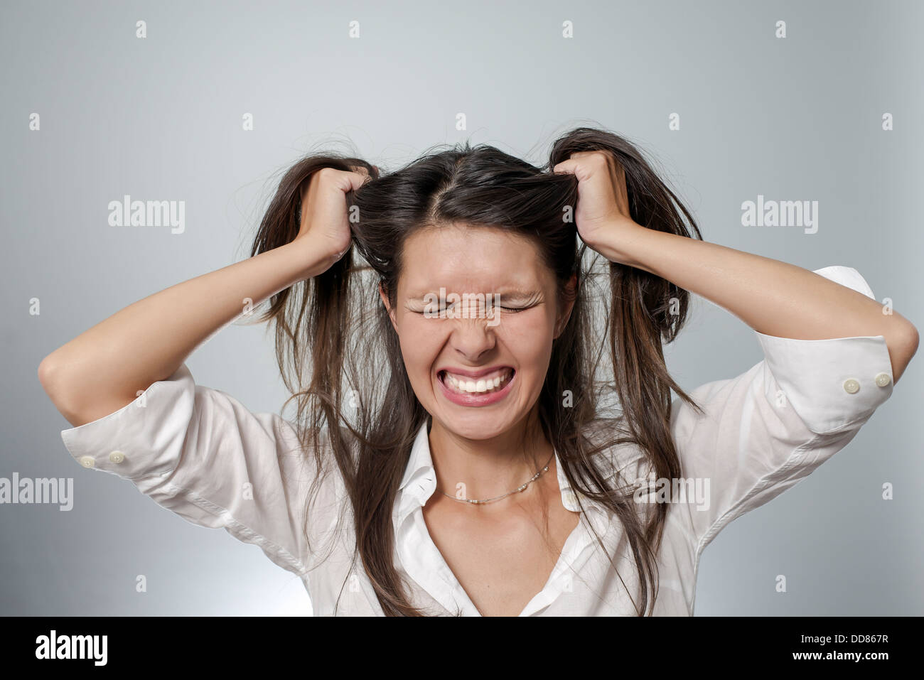 woman with headache and negative face expression - burn-out, depression, frustration, sickness Stock Photo