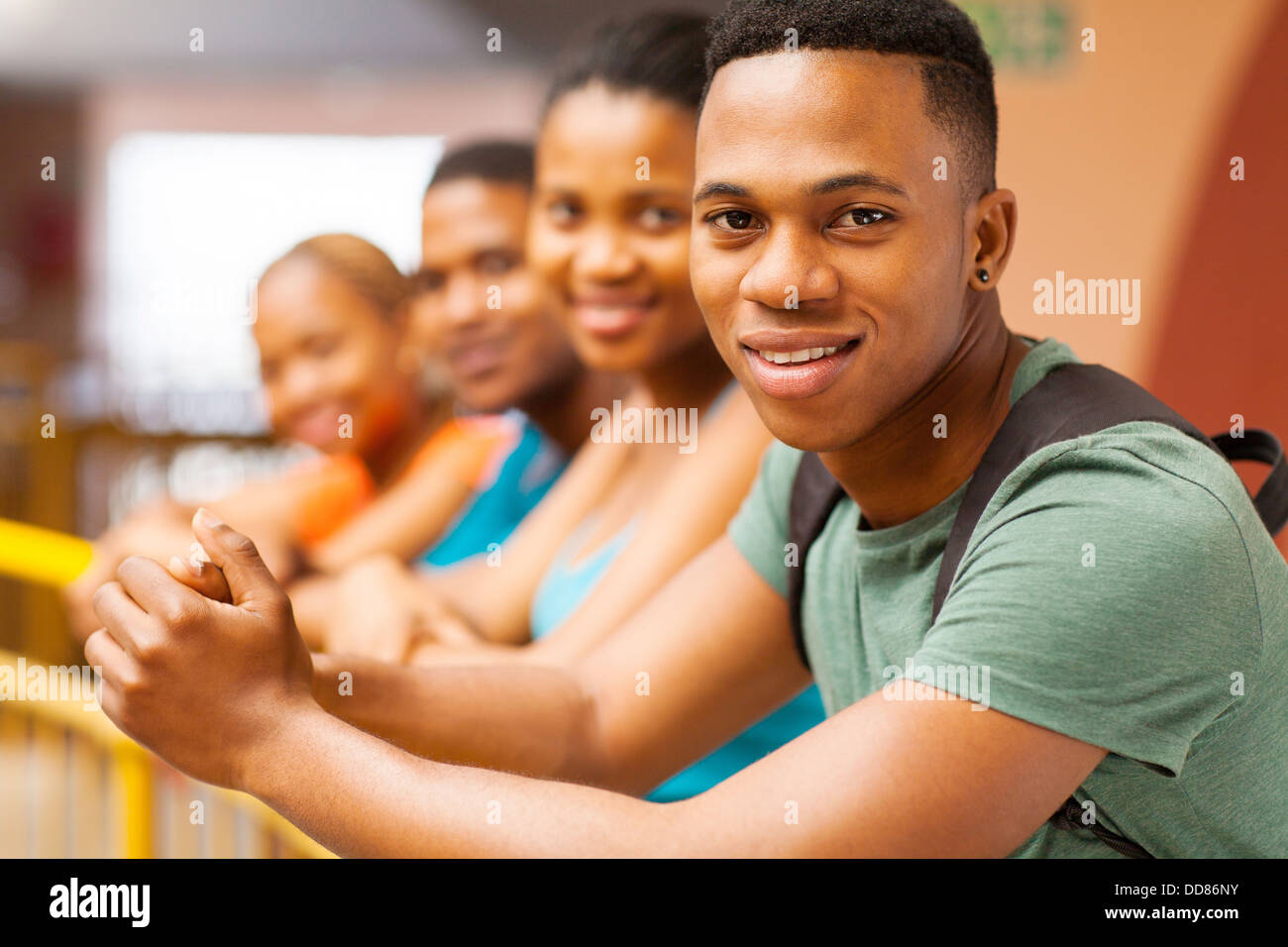 handsome young African college boy with group of friends Stock Photo
