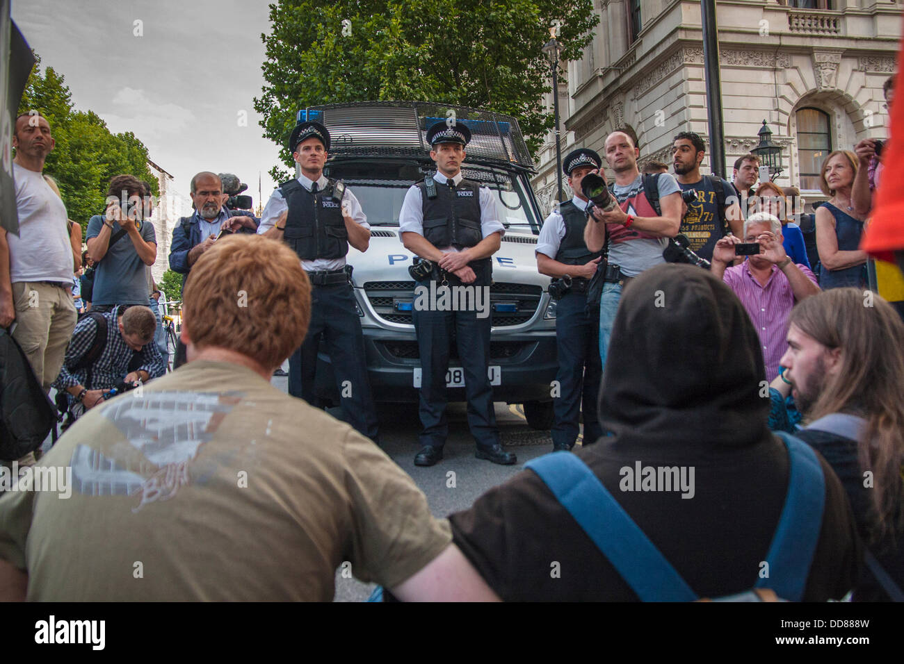 London, UK. 28th Aug, 2013. Police look on as activists block Whitehall during a protest against possible intervention by the UK in the ongoing Syrian conflict following chemical weapons attacks, Blamed on the Assad regime, on civilians. Credit:  Paul Davey/Alamy Live News Stock Photo
