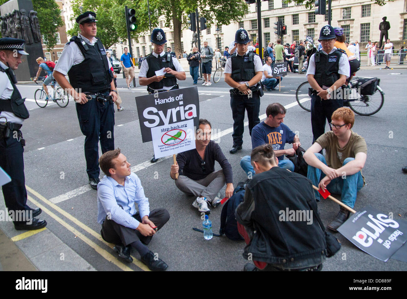 London, UK. 28th Aug, 2013. Police stand by to remove activists blocking Whitehall during a protest against possible intervention by the UK in the ongoing Syrian conflict following chemical weapons attacks, Blamed on the Assad regime, on civilians. Credit:  Paul Davey/Alamy Live News Stock Photo