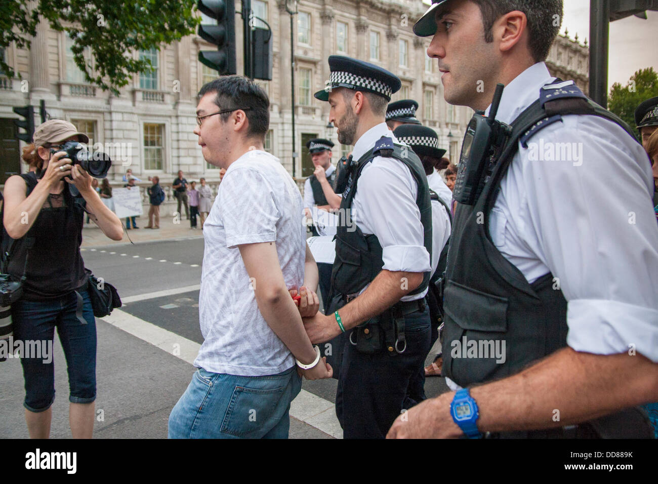 London, UK. 28th Aug, 2013. After refusing to move from Whitehall, and activist is led away by police during a protest against possible intervention by the UK in the ongoing Syrian conflict following chemical weapons attacks, Blamed on the Assad regime, on civilians. Credit:  Paul Davey/Alamy Live News Stock Photo