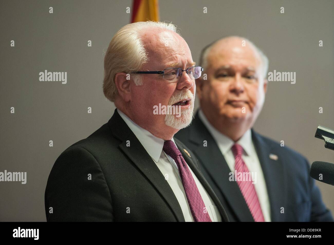 Tucson, Arizona, USA. 28th Aug, 2013. Under Secretary of the Army JOSEPH WESTPHAL, right, and Rep. RON BARBER (D-Ariz.), left, are in Barber's Southern Arizona district to tour military facilities and defense contractor plants. The men held a press conference at Tucson International Airport in Tucson, Ariz. after Westphal's arrival. Barber said he is leading Westphal's tour to make sure Westphal has an understanding of the importance of the military in Barber's district. Westphal said at this point there are no Administration plans for base realignment and closure programs becaus Stock Photo