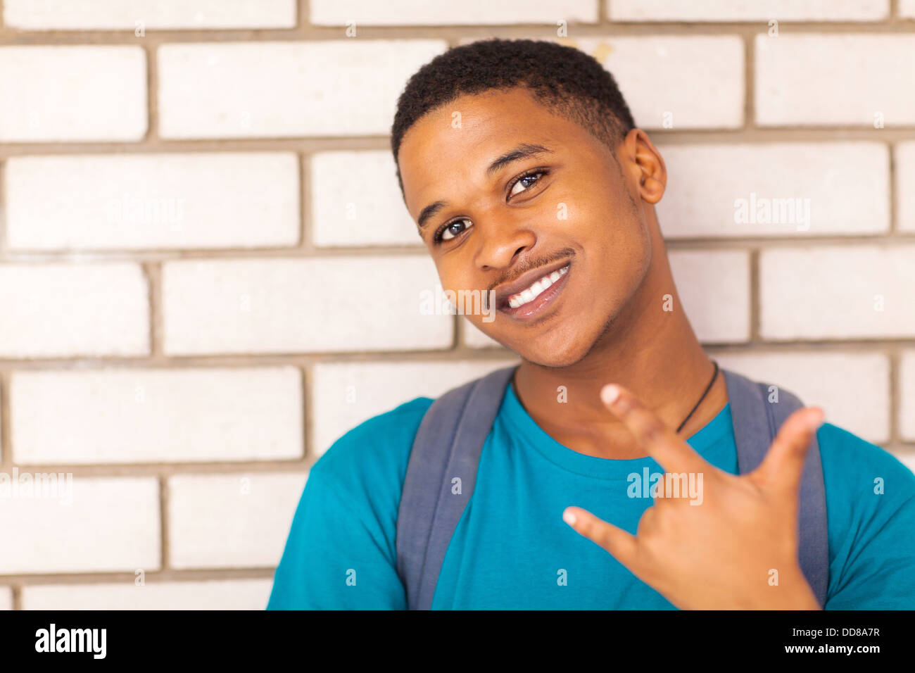 happy African American college boy giving hand sign Stock Photo - Alamy