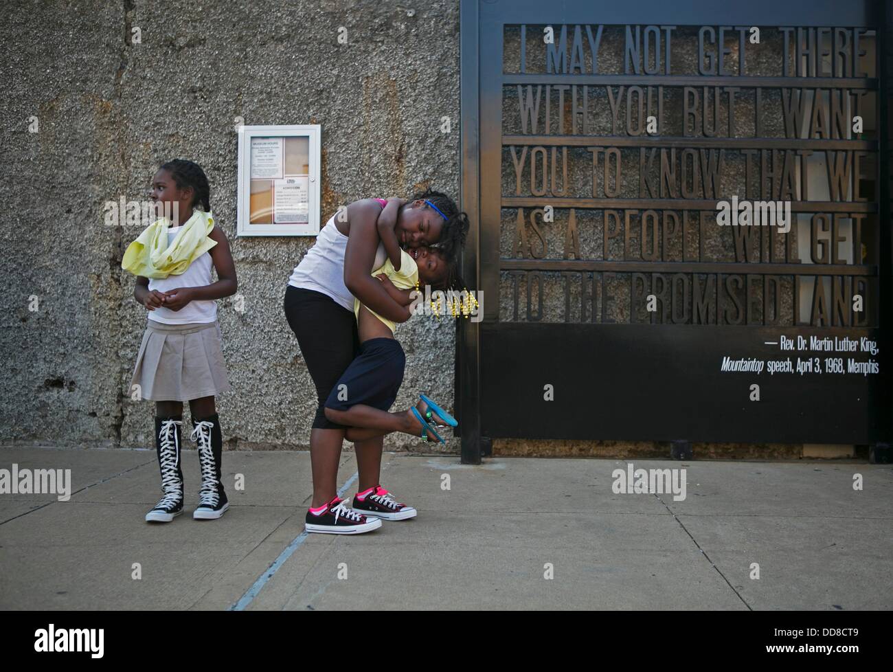 June 30, 2013 - U.S. - August 28, 2014 - Mikeiah Bowles, 9, watches a band perform while her sisters N'Tyra Bowles, 11, and Cyniah Bowles, 5, embrace during the commemoration of the 50th anniversary of the March on Washington at the National Civil Rights Museum in Memphis, TN on Wednesday. Tyrone Fields, 33, brought his daughters to the event, ''to show them that the dream is still alive and to keep the movement moving forward.'' The free event was inspired by the Rev. Martin Luther King, Jr.'s, ''I Have A Dream'', speech and the people who attended the March on Washington for Jobs and Freedom Stock Photo