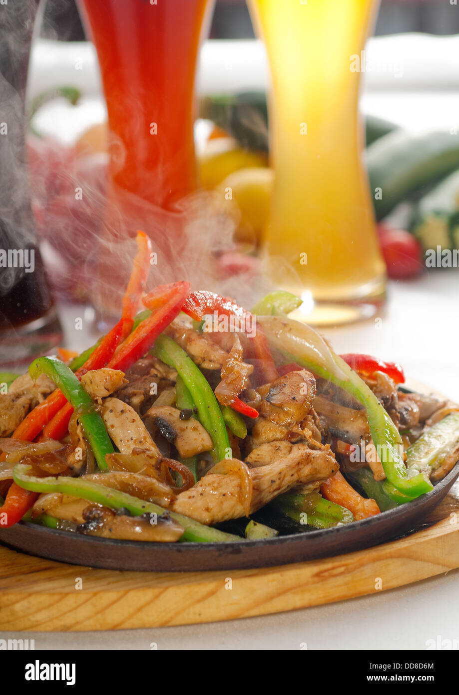 original fajita sizzling hot on iron plate Stock Photo Alamy