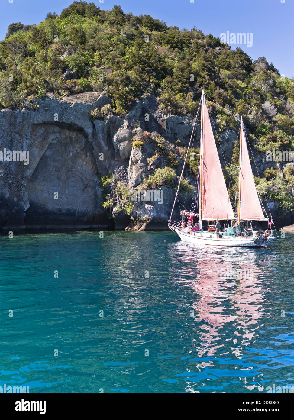 dh  LAKE TAUPO NEW ZEALAND Fearless sailing boat trip tourists Maori rock carving tourism sight seeing Stock Photo