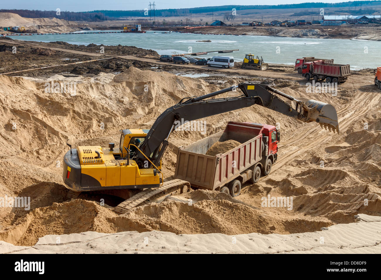 Excavator Loading Dumper Truck at Construction Site Stock Photo - Alamy