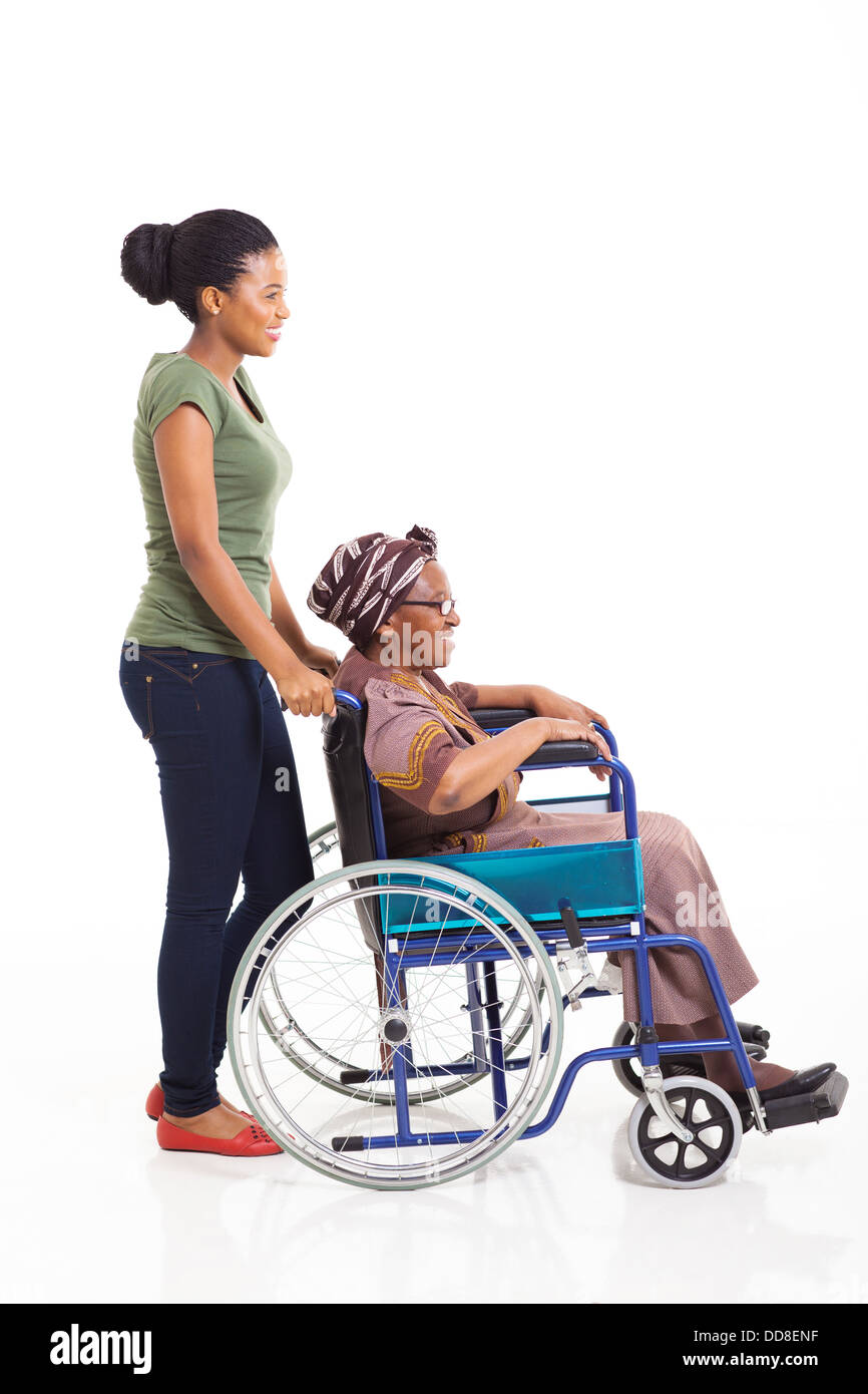 beautiful young African woman pushing grandmother on wheelchair isolated on white Stock Photo