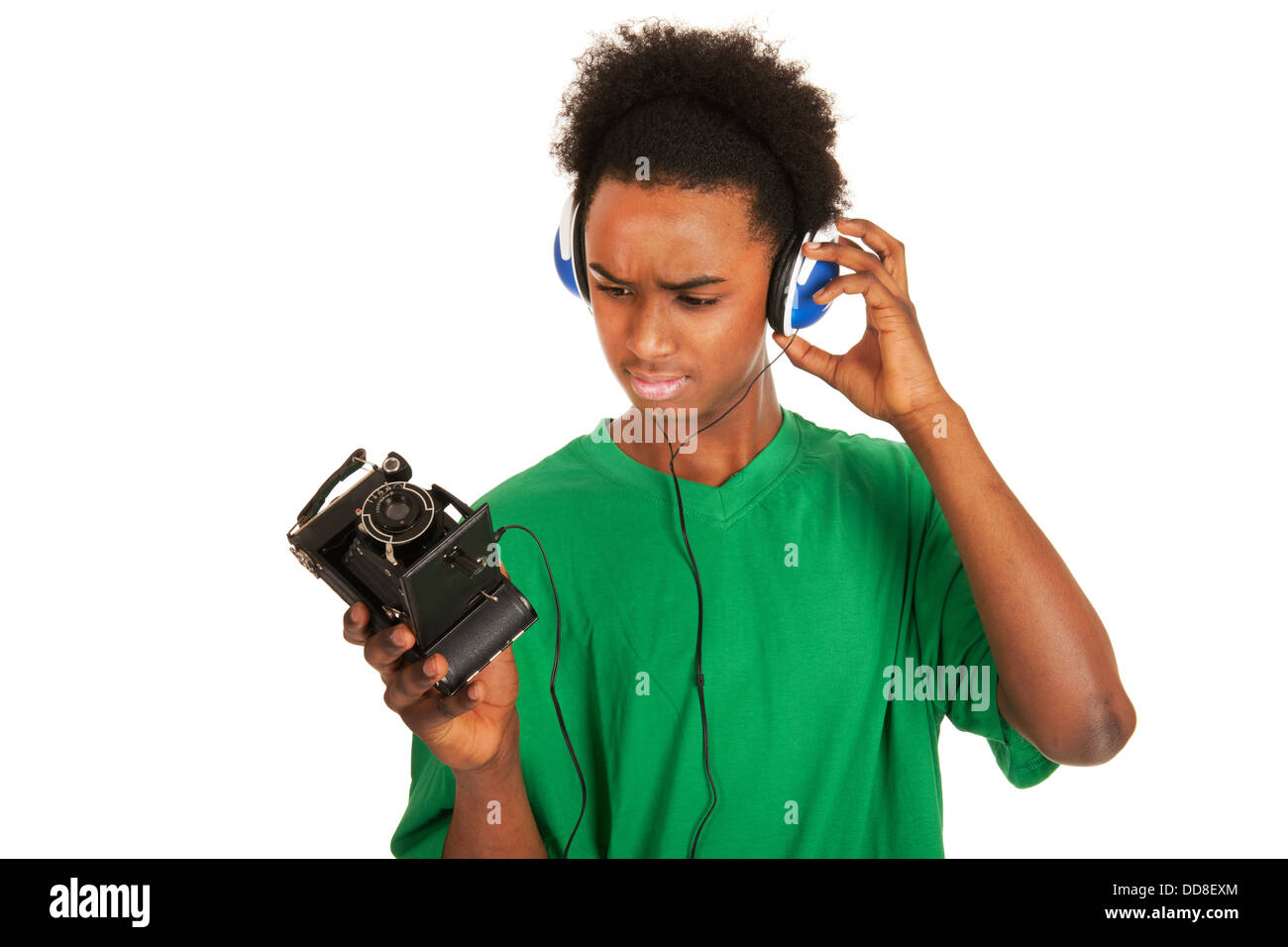 Teenager boy connecting with vintage photo camera Stock Photo