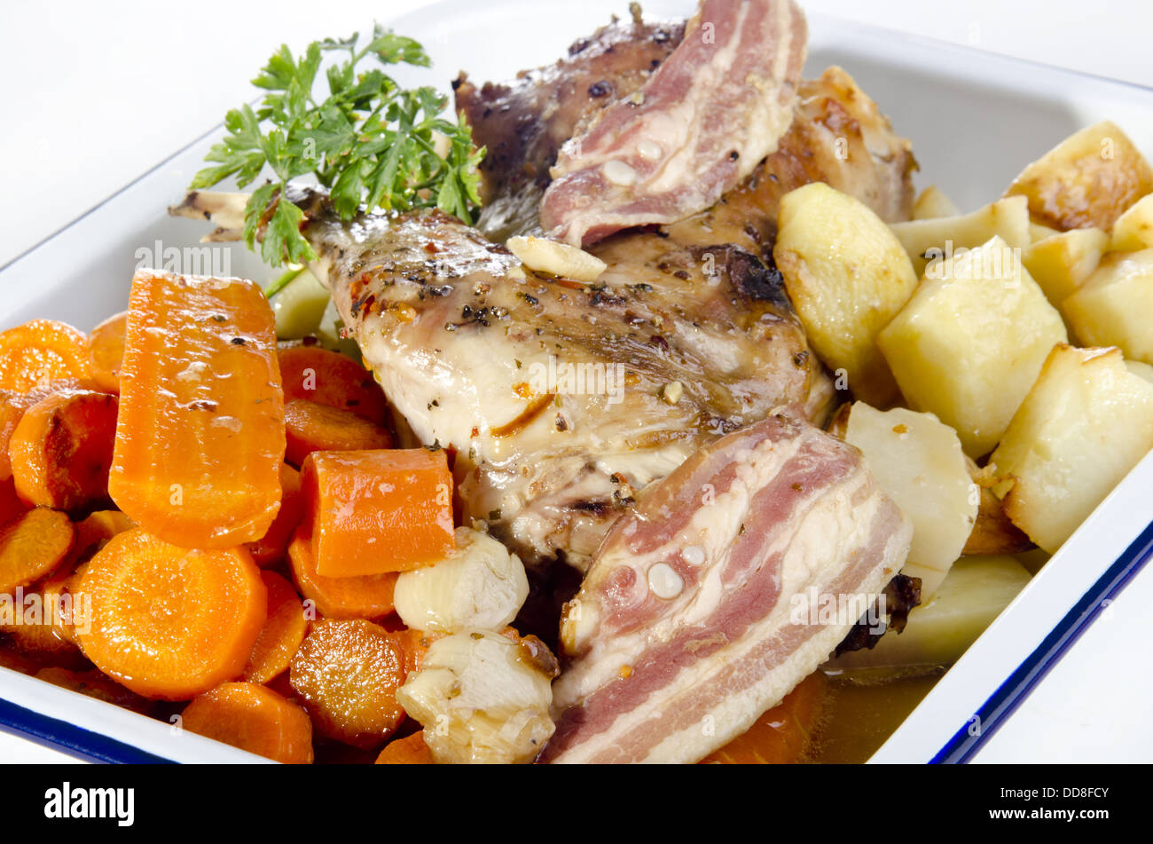 Full Grilled Rabbit grilled rabbit with bacon, carrot and potatoes Stock Photo - Alamy