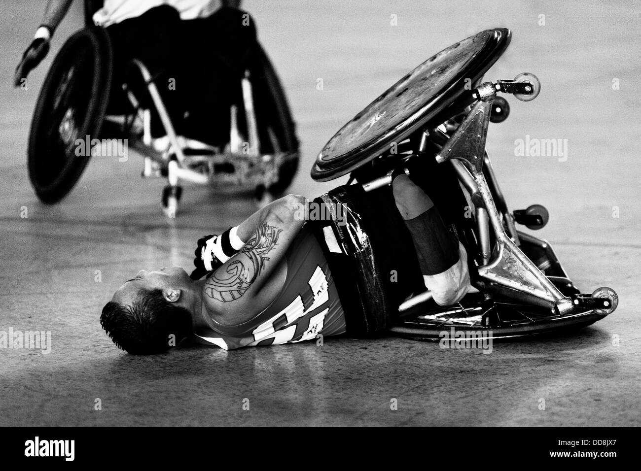 A Colombian disabled athlete tips over during a wheelchair rugby