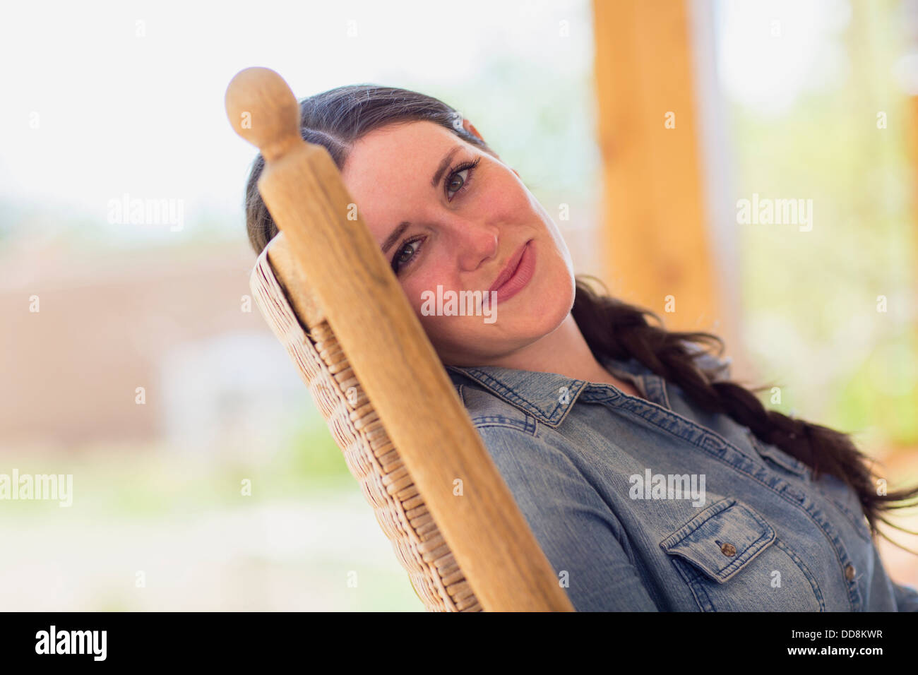 Caucasian woman relaxing in rocking chair Stock Photo Alamy