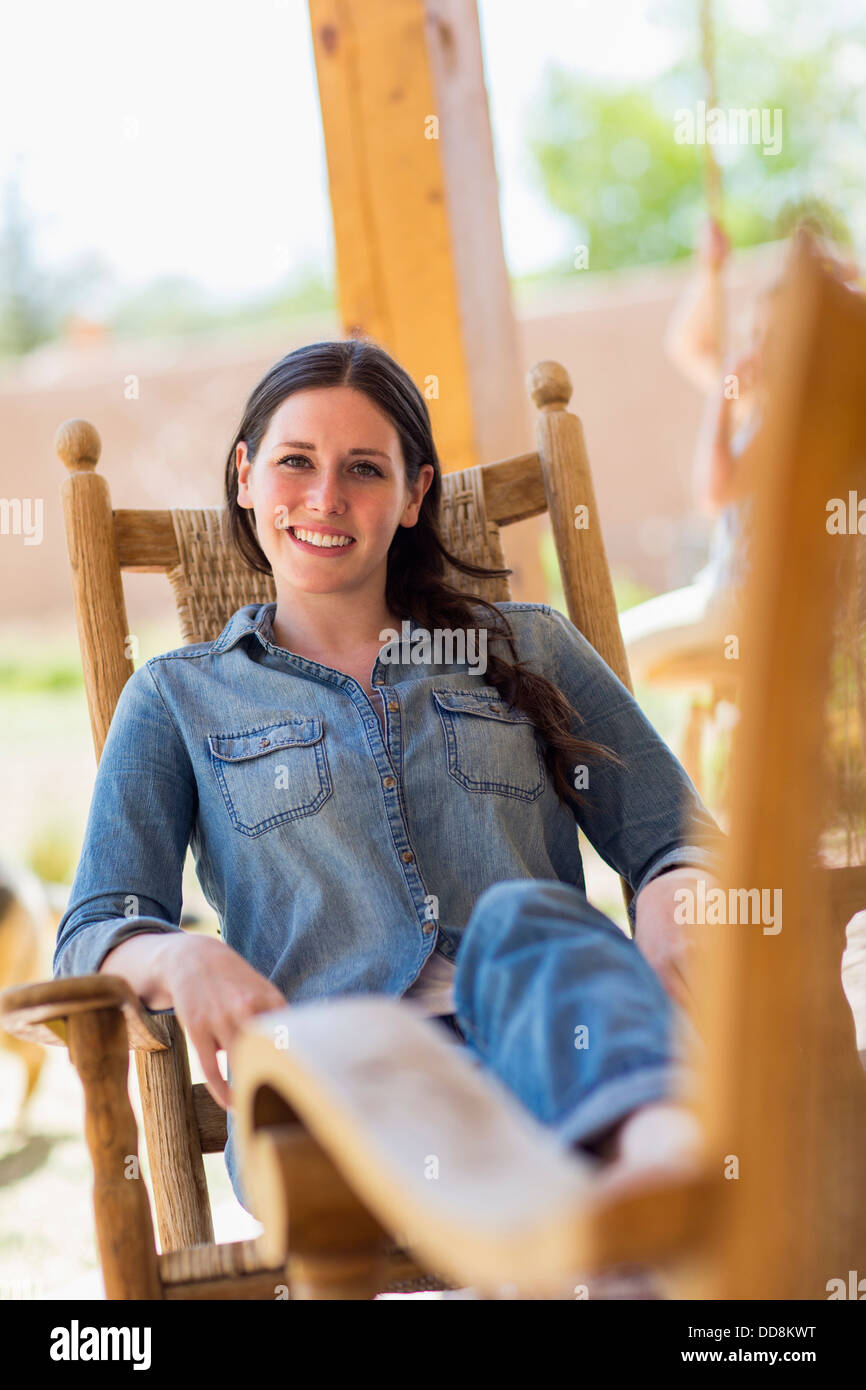 Caucasian woman relaxing in rocking chair Stock Photo