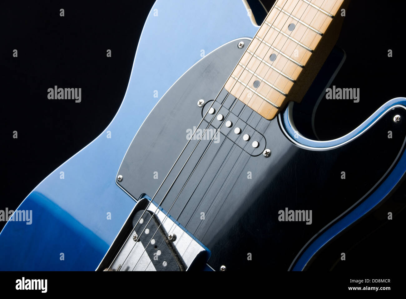 Section of an electric guitar body and neck in close-up. Stock Photo