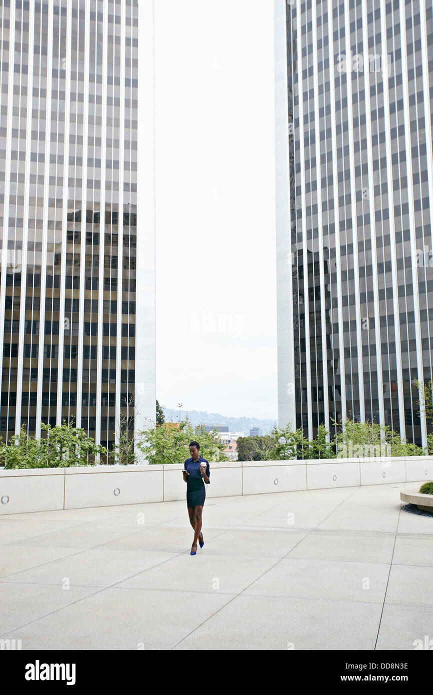 African American businesswoman walking on city street Stock Photo - Alamy