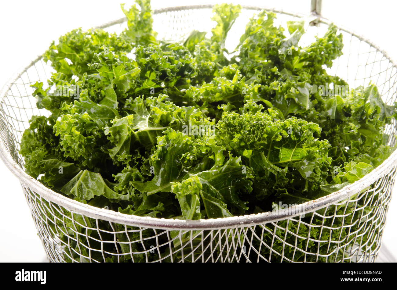 Washed and sliced curly kale in a colander Stock Photo Alamy