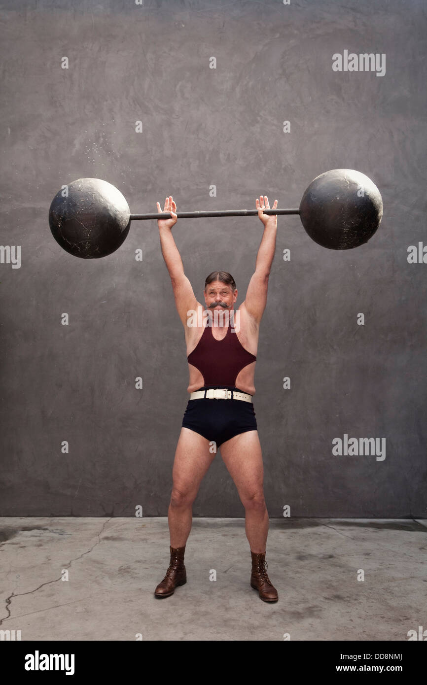 Caucasian weight lifter straining Stock Photo