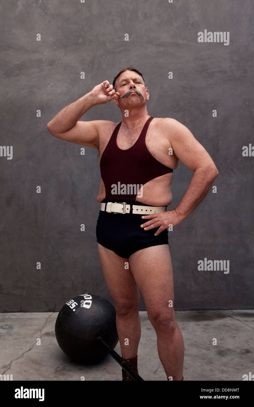 Caucasian weight lifter twirling his mustache Stock Photo