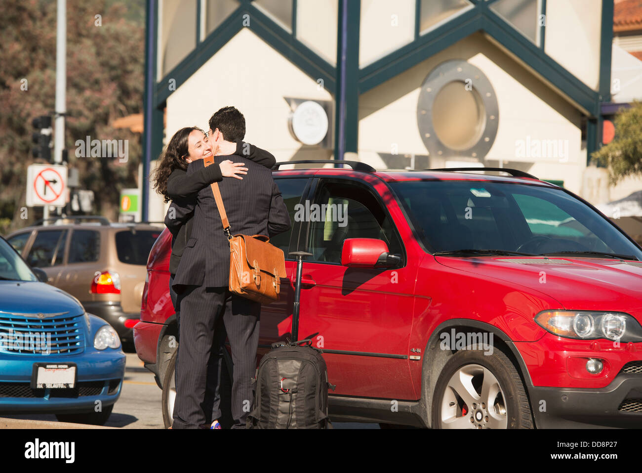 Hugging A Lod Hispanic couple hugging in parking lot Stock Photo - Alamy
